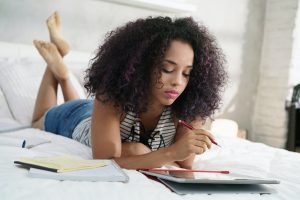 Technology For Young Hispanic Woman Studying With Laptop Computer